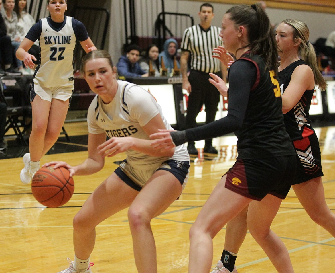 JASON ELLIOTT/Press Region center Diana Nelson attempts to drive past Metro guard Addy Bayne during the second half of the 22nd annual girls Idaho All-Star basketball game at North Idaho College on Saturday.