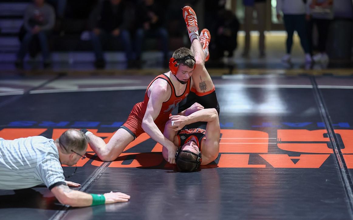 Freshman Porter Craig, who wrestled as a senior at Coeur d'Alene High in 2021, puts the shoulders of Clackamas freshman Josh Hannan on the mat during their match at 157 pounds on Wednesday at Christianson Gymnasium.