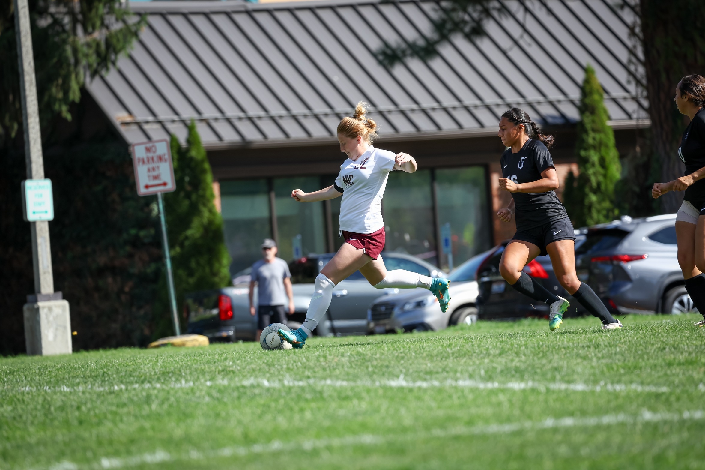 Soccer player Macie McElhenney brings ball down the field.