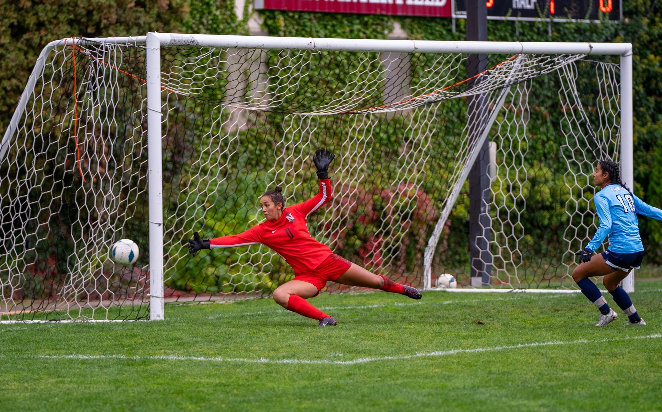 Goalie Kaycee Chavez attempts a save against Columbia Basin player.